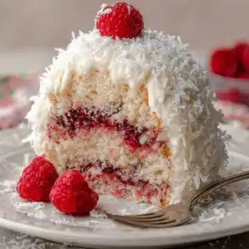 Raspberry Surprise Coconut Snowball Cake